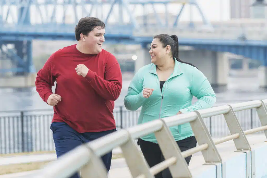 OVERWEIGHT COUPLE JOGGING TO LOSE WEIGHT