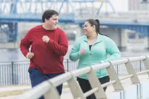OVERWEIGHT COUPLE JOGGING TO LOSE WEIGHT